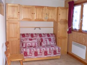 a small bedroom with a bed and a chair at Appartement Saint-Jean-d'Aulps, 3 pièces, 6 personnes - FR-1-573-32 in Saint-Jean-d'Aulps