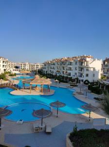 vistas a una piscina con sombrillas y edificios en Rivera Sharm Habiba Apartments, en Sharm El Sheikh