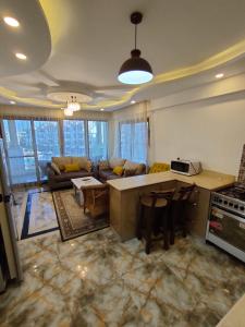 a large kitchen and living room with a couch at Rivera Sharm Habiba Apartments in Sharm El Sheikh