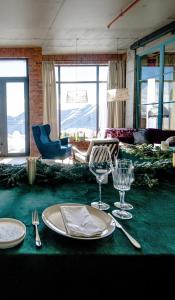 a table with plates and wine glasses on top of a living room at Ati Ambavi Botique Hotel Gudauri in Gudauri