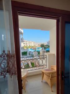 a door to a balcony with a view of a city at Rivera Sharm Habiba Apartments in Sharm El Sheikh
