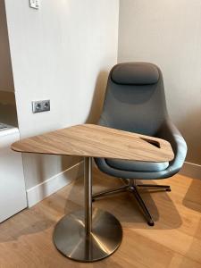 a desk with a chair and a wooden table at Holiday Inn Express - Madrid - Airport, an IHG Hotel in Madrid