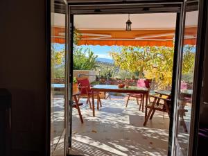 a glass door leading to a patio with a table and chairs at Villa Spa Los Villares in Jaén