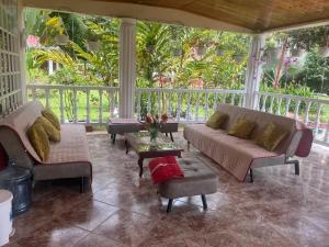 a screened in porch with a couch and chairs at EL ANHELO in Cumaral