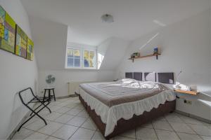 a bedroom with a bed and a chair in it at Ferienwohnung Panorama Moselblick in Treis-Karden
