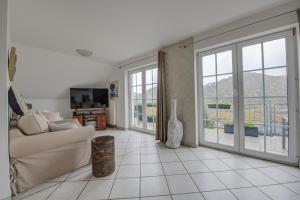 a living room with a couch and sliding glass doors at Ferienwohnung Panorama Moselblick in Treis-Karden