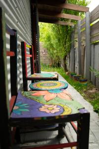 a group of tables with colorful paintings on them at El Kamaruco Chaltén Tiny House de Montaña in El Chalten