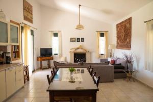 a living room with a couch and a table at Villa Christina Anidri in Ánidhroi
