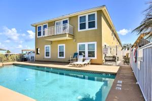 a house with a swimming pool in front of a house at Waterfront Corpus Christi Townhome with Pool and Dock! in Corpus Christi