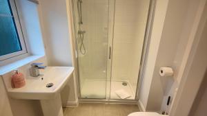 a bathroom with a shower and a sink and a toilet at Saxon Corner in Emsworth +18 photos