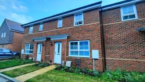 a brick building with a car parked in front of it at Saxon Corner in Emsworth