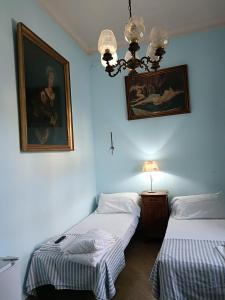 two beds in a room with two pictures on the wall at Mavipagi in Verona