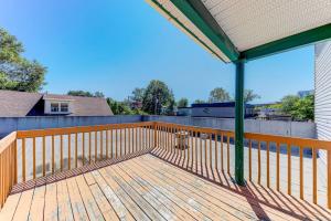a porch with a wooden deck with a fire hydrant at The 1810 - Spacious with balcony - North of Quebec in Quebec City