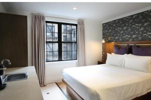 a hotel room with a bed and a window at Hotel Scherman in New York