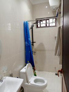 a bathroom with a toilet and a shower and a sink at Kendwa Cool and Calm Hotel limited in Kendwa