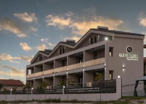 a large white building with a sign on it at San Giorgio Apartments Nikiti in Nikiti