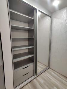 a walk in closet with a glass door at Rika apartments in Chernivtsi