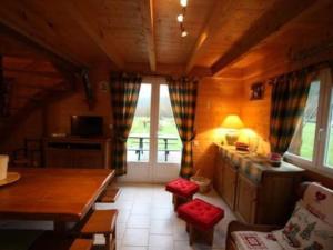 a living room with a table and a large window at chalet de montagne in Vagney