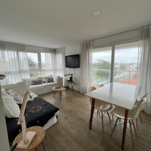 a living room with a couch and a table at Depto. Con vista al mar a estrenar in Mar del Plata