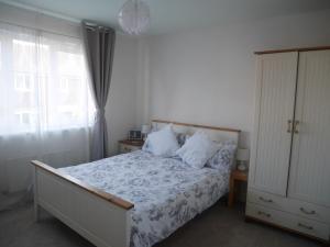 a bedroom with a bed and a large window at Cliffwalk Cottage in Portland