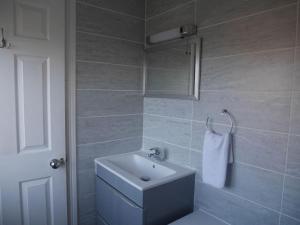 a bathroom with a sink and a white towel at Cliffwalk Cottage in Portland +18 photos