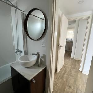 a bathroom with a sink and a mirror at Depto. Con vista al mar a estrenar in Mar del Plata