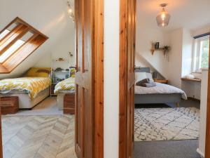 a attic bedroom with two beds and a window at Hillsview in Ilfracombe