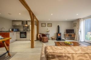 a living room with a couch and a table at The Barns at Green Valley Farm in Heveningham