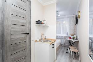 a small kitchen with a sink and a door at Отличная студия в центре in Almaty