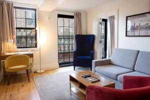a living room with a couch and a chair at Hotel Scherman in New York