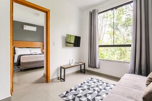 a living room with a bed and a mirror at Flats das Palmeiras in Florianópolis