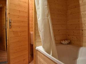 a wooden bathroom with a tub and a shower at Appartement cosy avec cheminée, terrasse et parking, proche pistes et commerces - Méribel - FR-1-180-552 in Méribel +22 photos