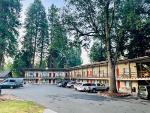 un edificio con coches estacionados en un estacionamiento en Shasta Inn, en Mount Shasta