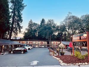 un parcheggio con auto parcheggiate di fronte a un edificio di Shasta Inn a Mount Shasta