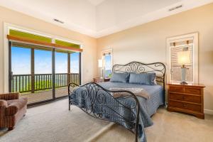 a bedroom with a bed and a balcony at Views for Miles at the Reserve in Sugar Mountain