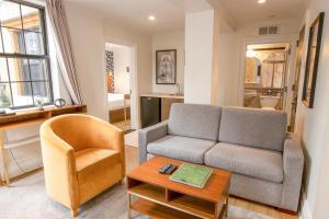 a living room with a couch and a chair at Hotel Scherman in New York