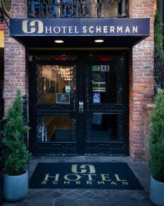 a hotel entrance with a sign on the door at Hotel Scherman in New York