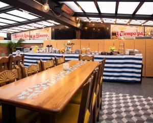 a long wooden table and chairs in a restaurant at Hotel Scherman in New York