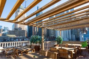 a patio with tables and chairs and a view of the city at Hotel Scherman in New York