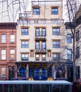 an apartment building with a balcony in front of it at Hotel Scherman in New York