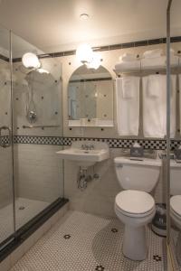 a bathroom with a toilet and a sink and a shower at Hotel Scherman in New York