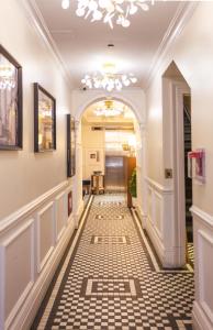 a hallway with a tile floor and a chandelier at Hotel Scherman in New York