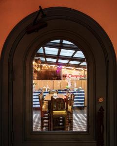 an arched window looking into a restaurant with a table and chairs at Hotel Scherman in New York