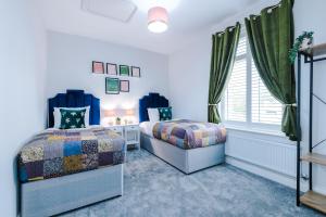 sypialnia z 2 łóżkami i oknem w obiekcie Parkview Place Serviced Apartment w Coventry