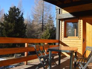 un tavolo e sedie sul portico di una cabina di Chalet Bolquère-Pyrénées 2000, 3 pièces, 6 personnes - FR-1-592-5 a Bolquere Pyrenees 2000