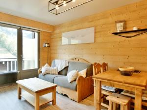 a living room with a couch and a table at Appartement Le Grand-Bornand, 2 pièces, 6 personnes - FR-1-391-119 in Le Grand-Bornand