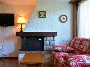 a living room with a couch and a fireplace at Appartement Le Grand-Bornand, 3 pièces, 6 personnes - FR-1-241-229 in Le Grand-Bornand