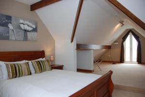 a bedroom with a large bed and a window at The Port House in Heysham