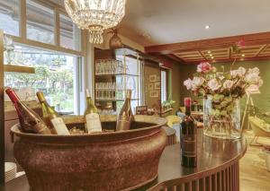 a room with a bunch of bottles of wine on a table at Gartenheim Tramin in Termeno