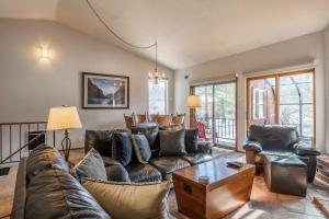a living room with a couch and a table at 2 bedroom 3 bath in Forest Creek 35 sleeps 5 Just steps to free town shuttle Great Views in Mammoth Lakes